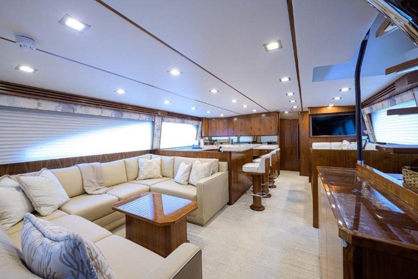 a living room with a couch and a table aboard 50 CALIBER Yacht for Sale