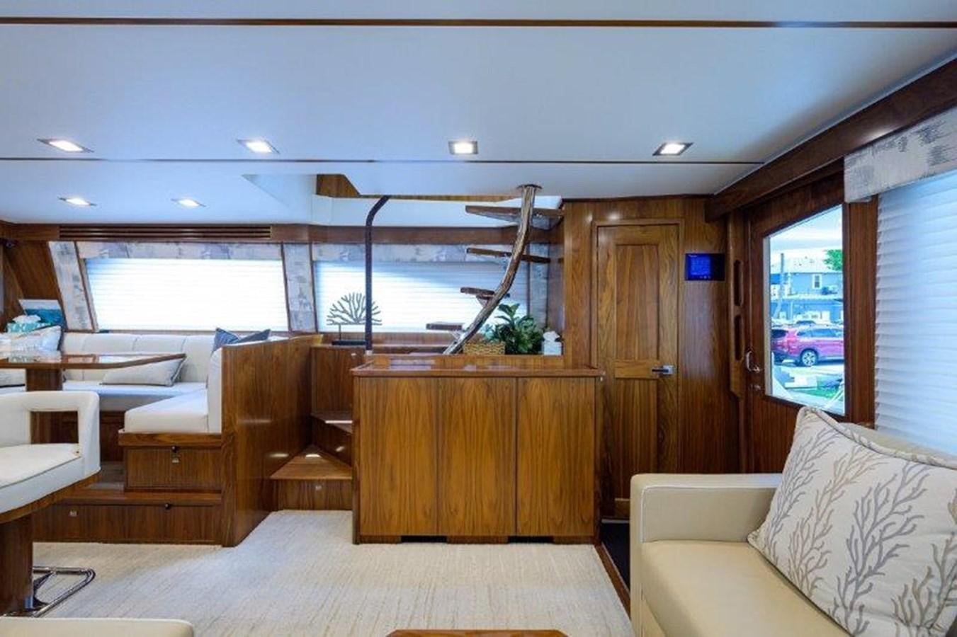 a room with a wood wall and a window with a view of the water aboard 50 CALIBER Yacht for Sale