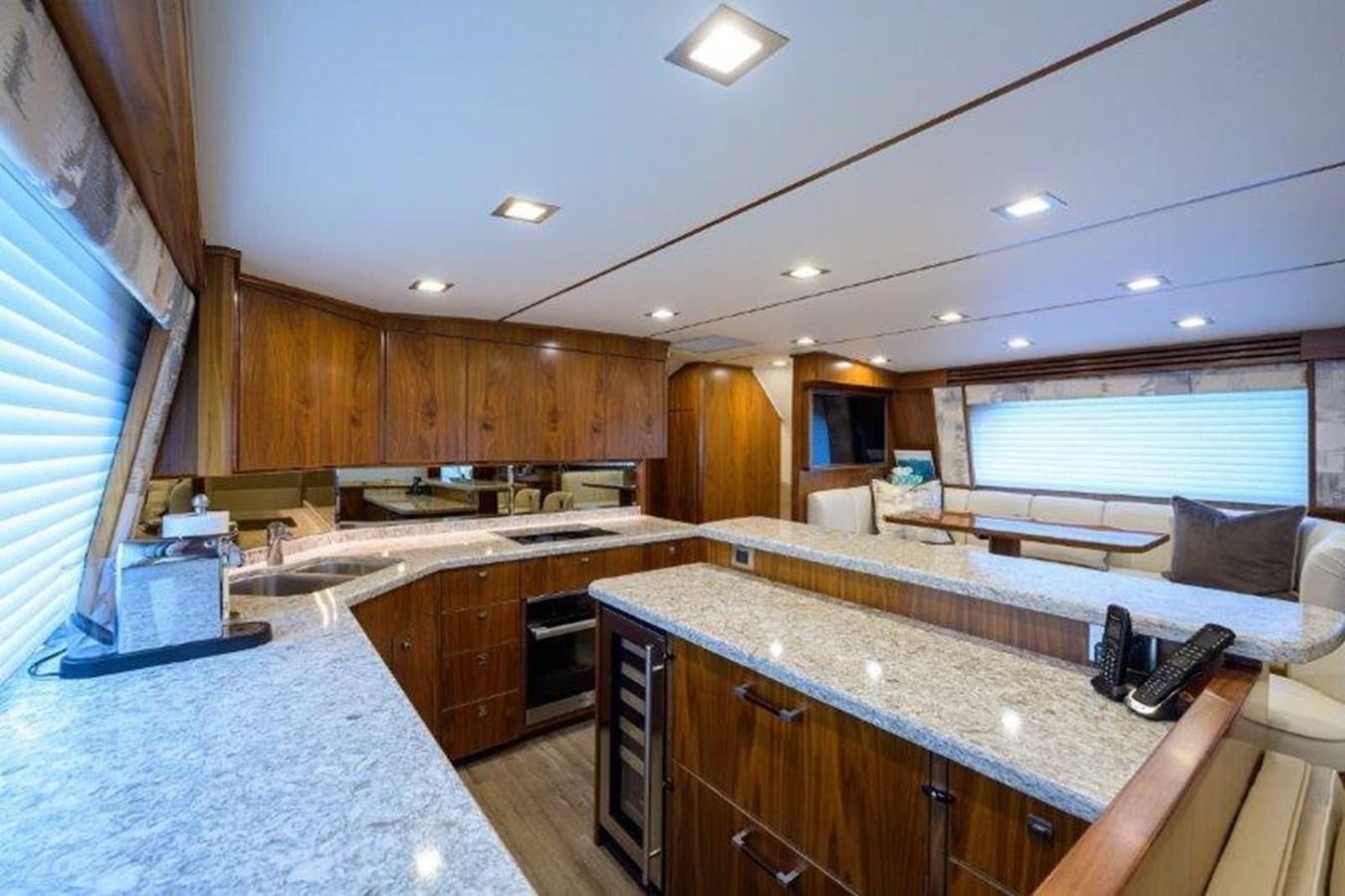a large kitchen with wooden cabinets aboard 50 CALIBER Yacht for Sale