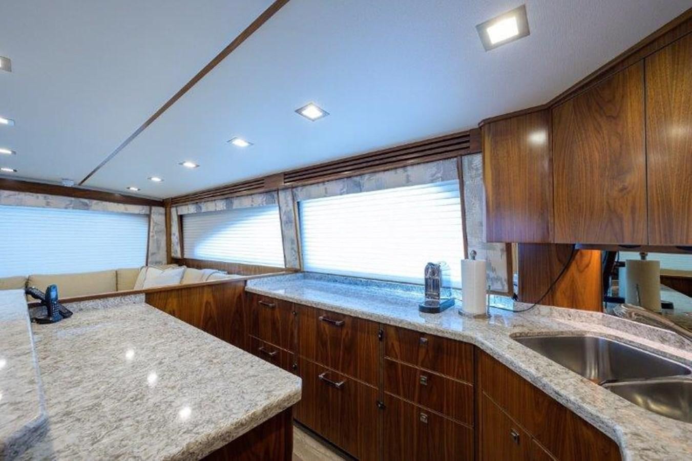 a kitchen with wooden cabinets aboard 50 CALIBER Yacht for Sale