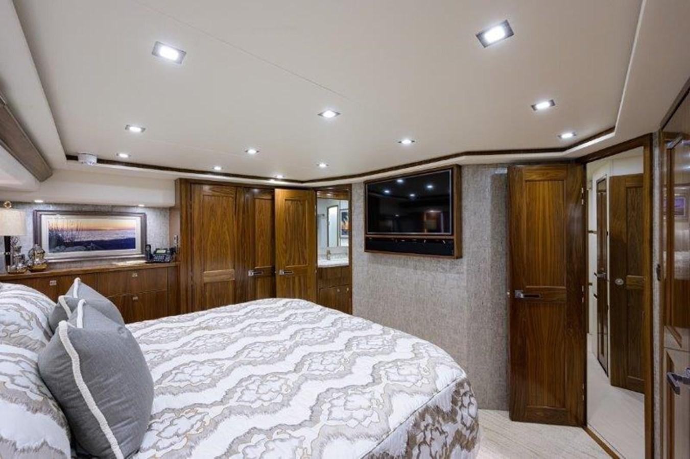 a bedroom with a bed and a television aboard 50 CALIBER Yacht for Sale