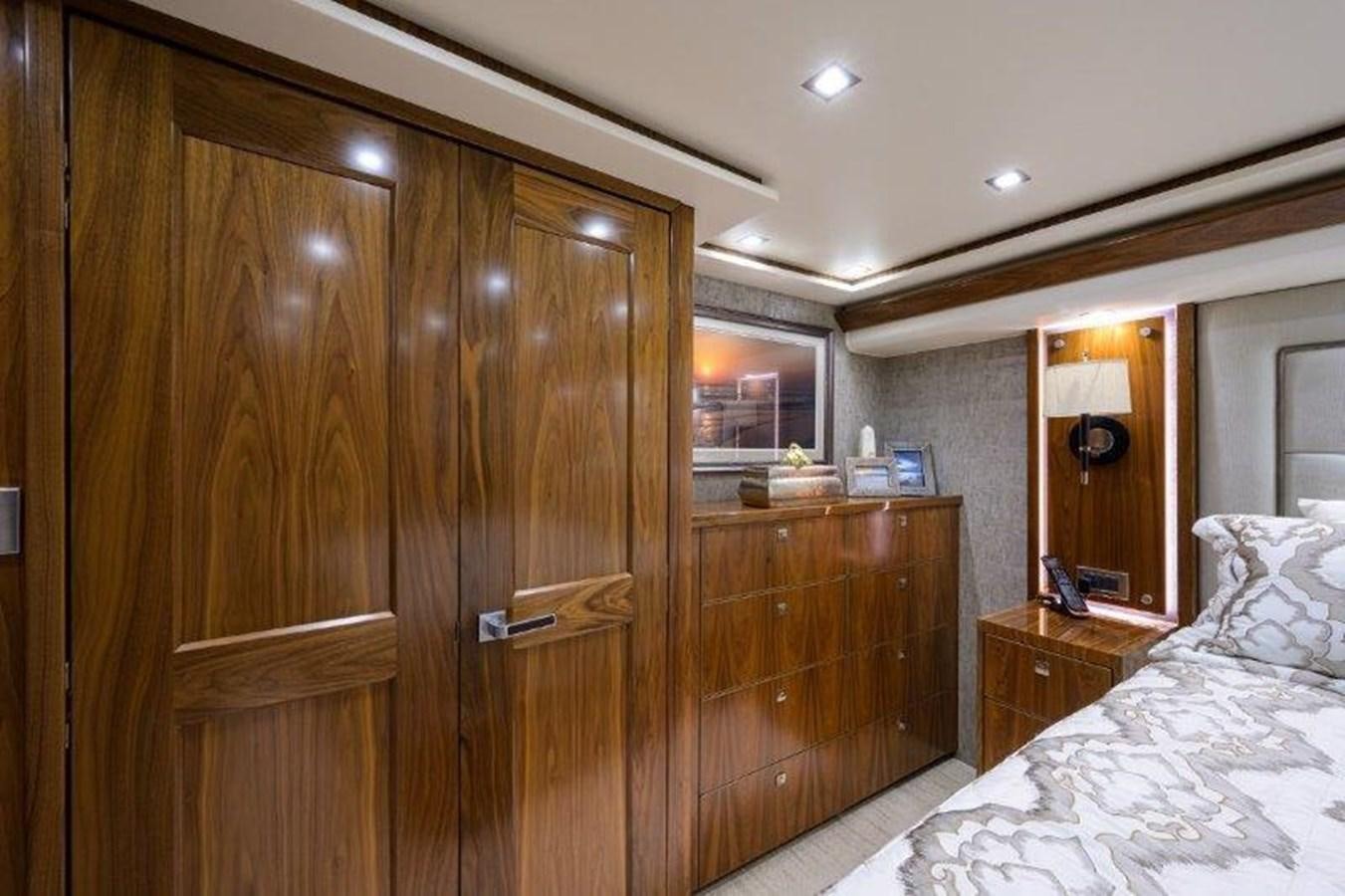 a wooden wardrobe in a bedroom aboard 50 CALIBER Yacht for Sale
