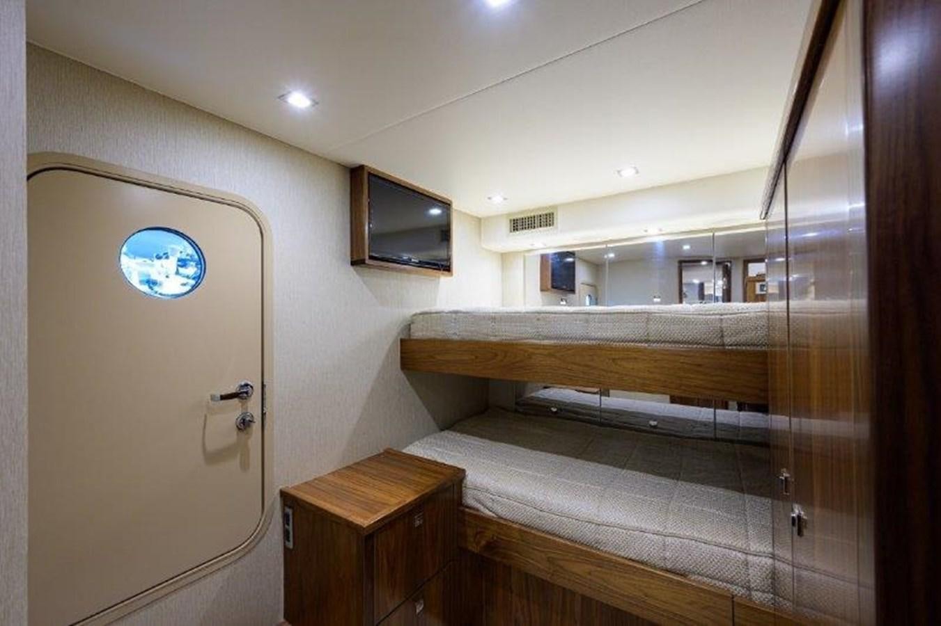 a room with a wood cabinet and a tv on the wall aboard 50 CALIBER Yacht for Sale
