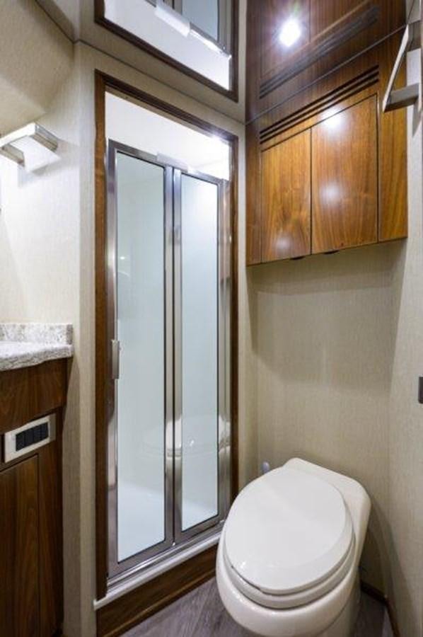 a bathroom with a glass shower door aboard 50 CALIBER Yacht for Sale