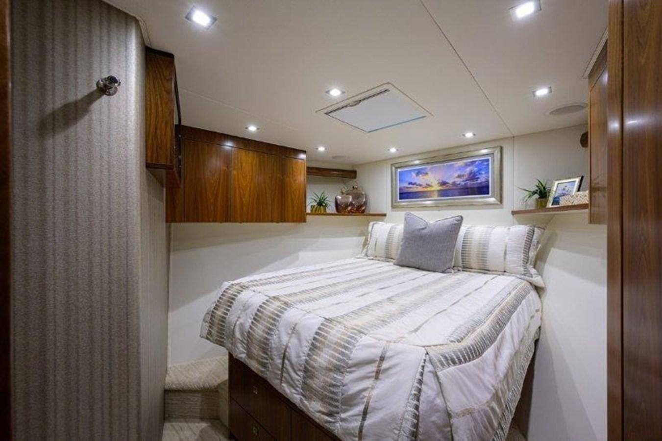 a bedroom with a bed and a television aboard 50 CALIBER Yacht for Sale