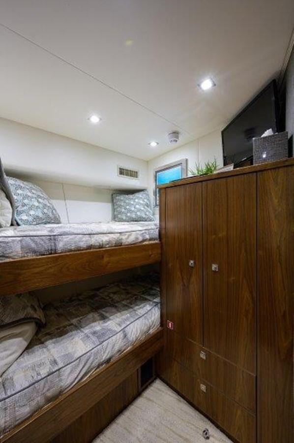 a room with a bed and a closet aboard 50 CALIBER Yacht for Sale