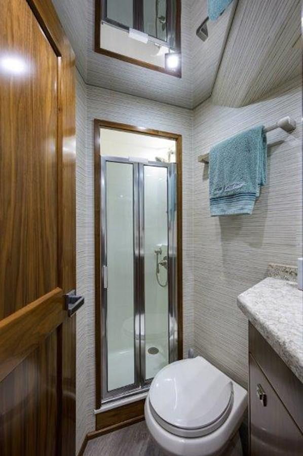 a bathroom with a toilet and a sink aboard 50 CALIBER Yacht for Sale