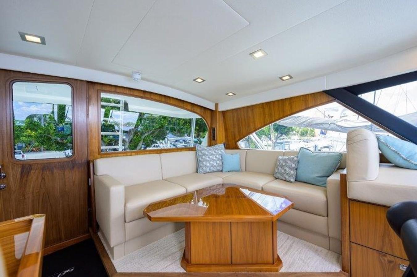 a living room with a couch and a table aboard 50 CALIBER Yacht for Sale