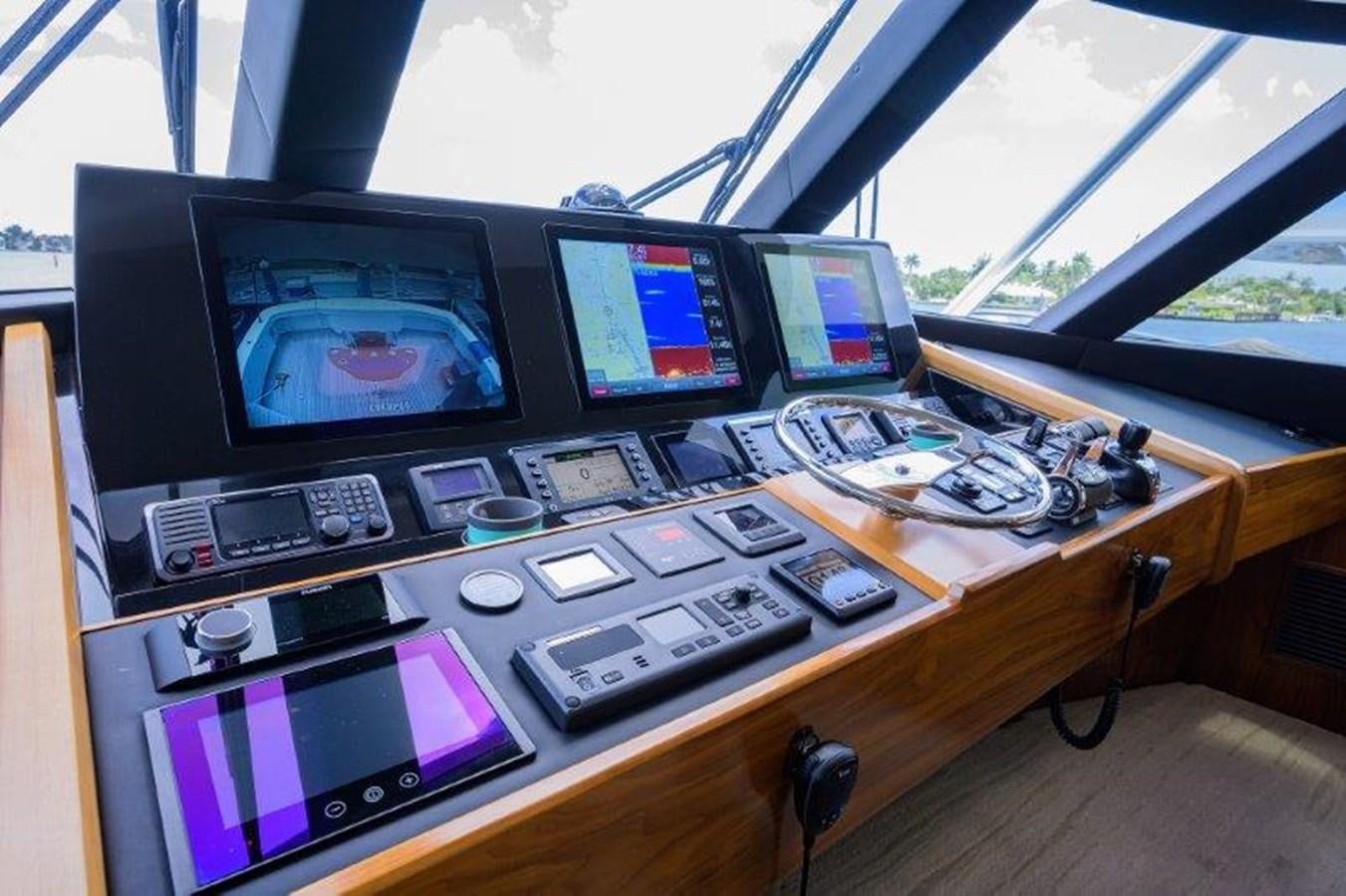 a desk with computers and electronics aboard 50 CALIBER Yacht for Sale