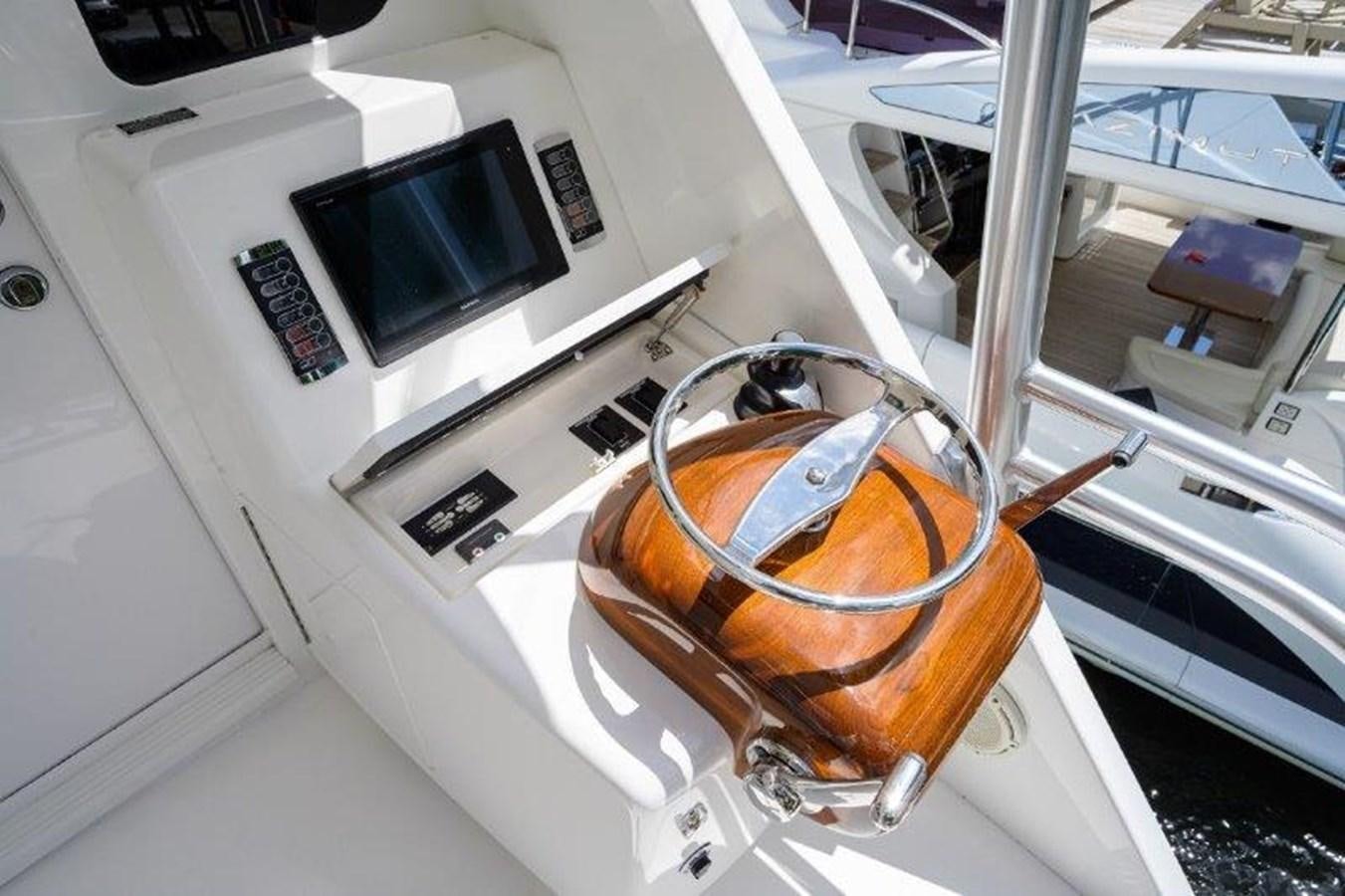a glass of brown liquid on a white machine aboard 50 CALIBER Yacht for Sale