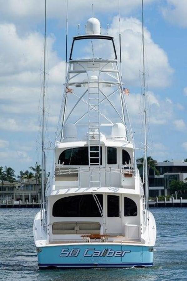 a white boat in the water aboard 50 CALIBER Yacht for Sale