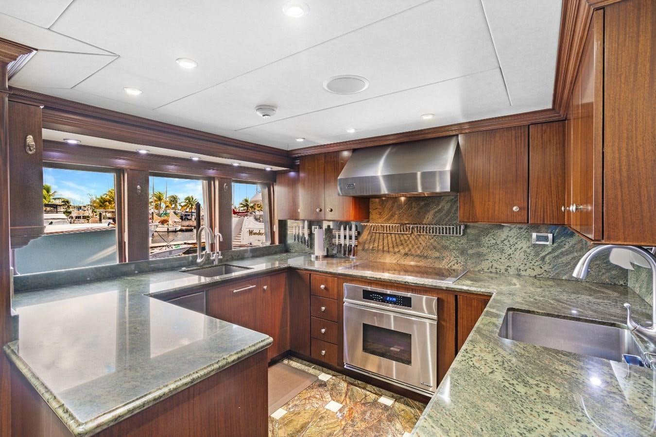 a kitchen with wooden cabinets aboard GITANA Yacht for Charter