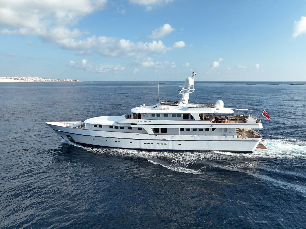 a white yacht on the water aboard CHEETAH MOON Yacht for Sale