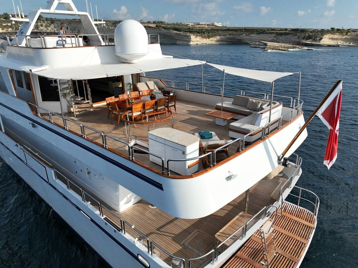 a boat with a flag on the deck aboard CHEETAH MOON Yacht for Sale