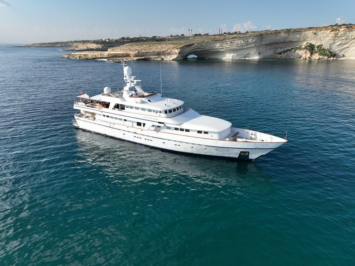 a white yacht in the water aboard CHEETAH MOON Yacht for Sale