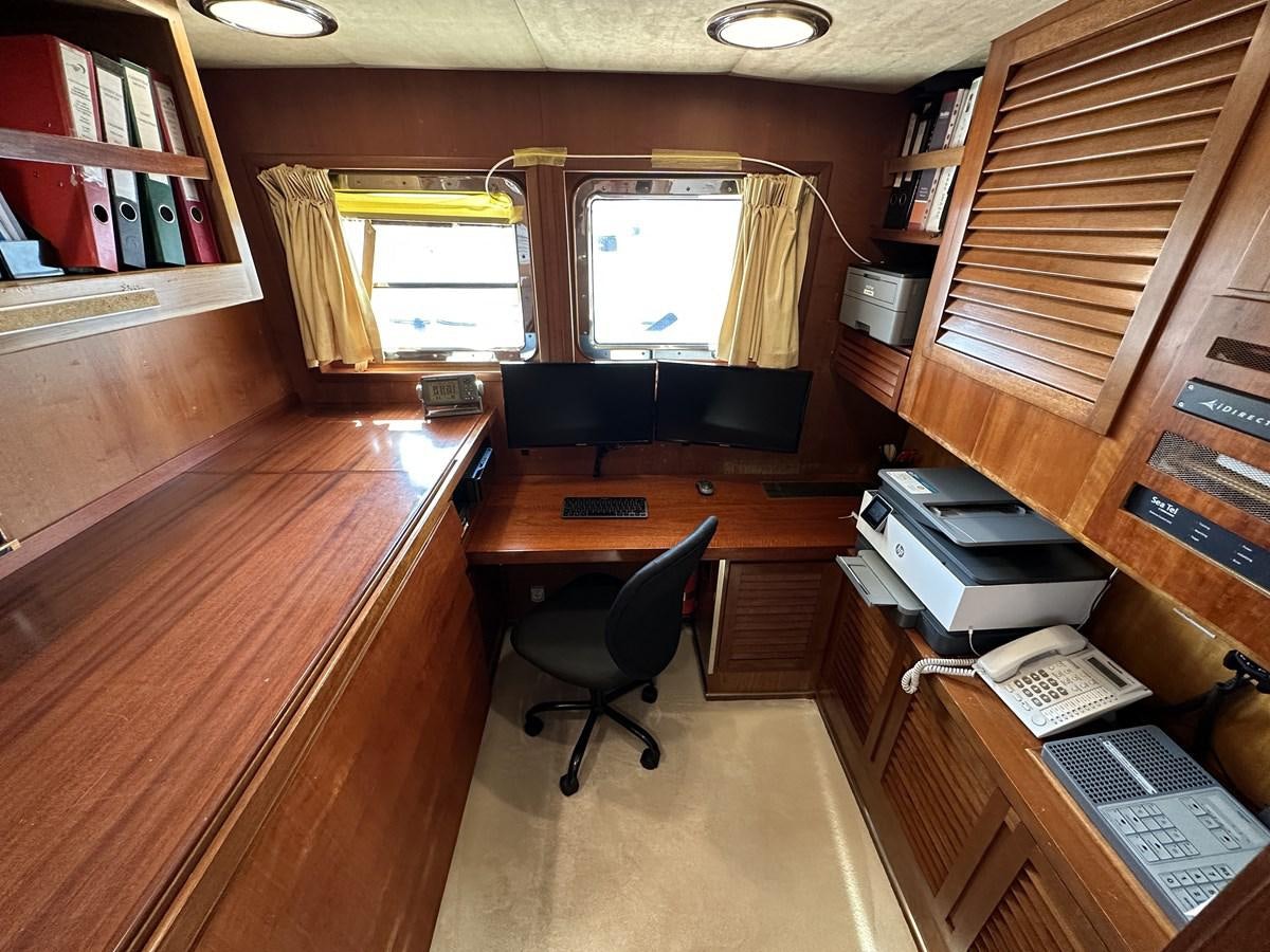 a room with a desk and a chair aboard CHEETAH MOON Yacht for Sale