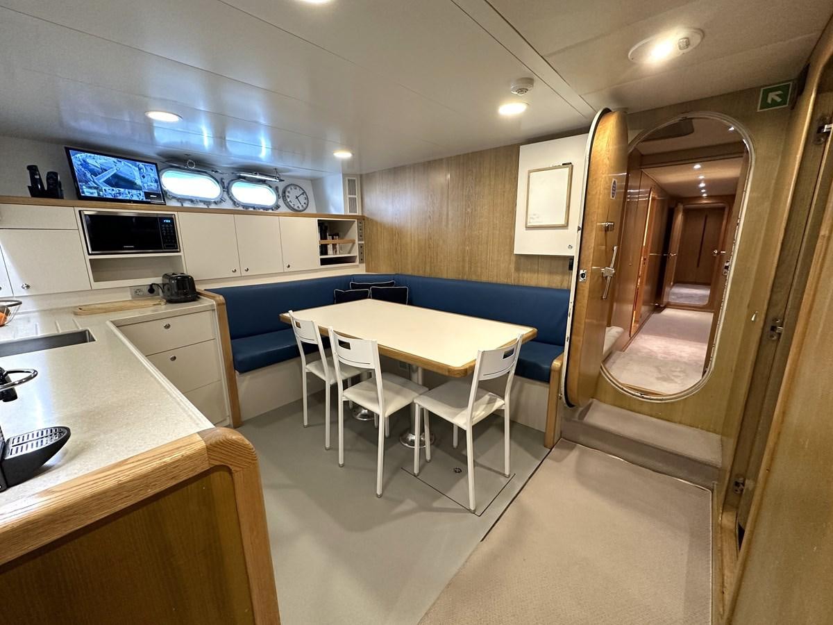 a room with a table and chairs aboard CHEETAH MOON Yacht for Sale