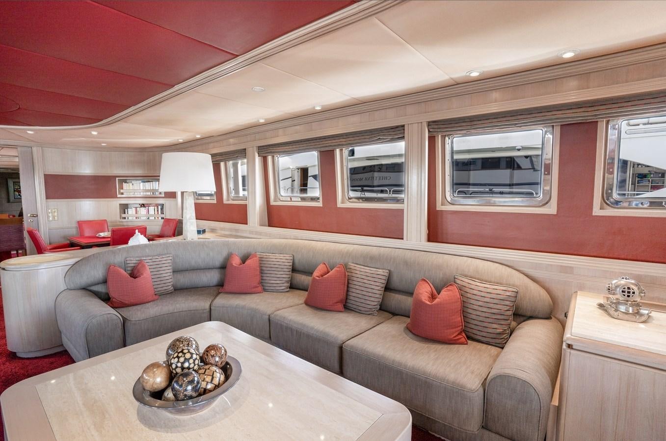 a living room with a couch and a table aboard CHEETAH MOON Yacht for Sale