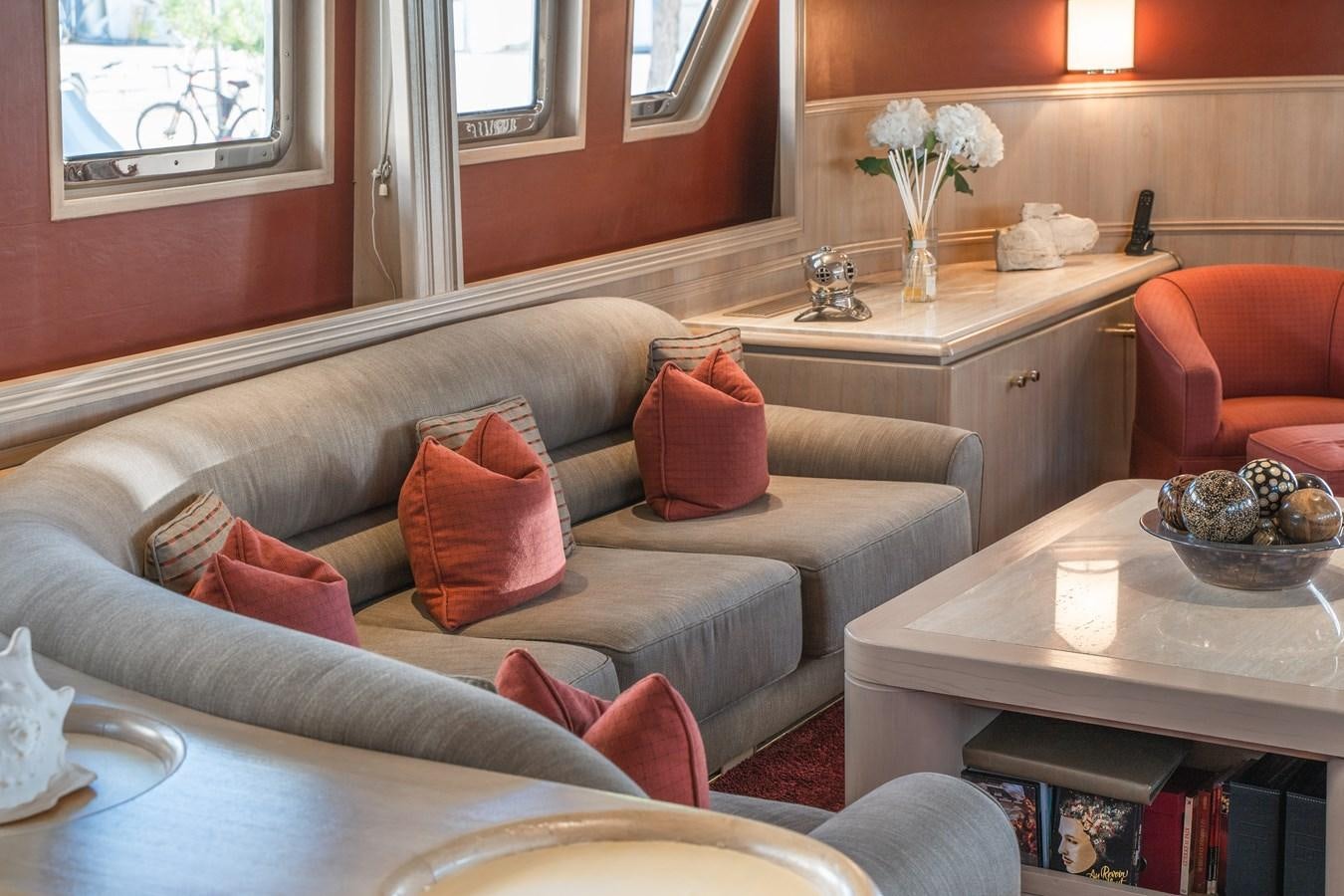 a living room with a couch and a table aboard CHEETAH MOON Yacht for Sale