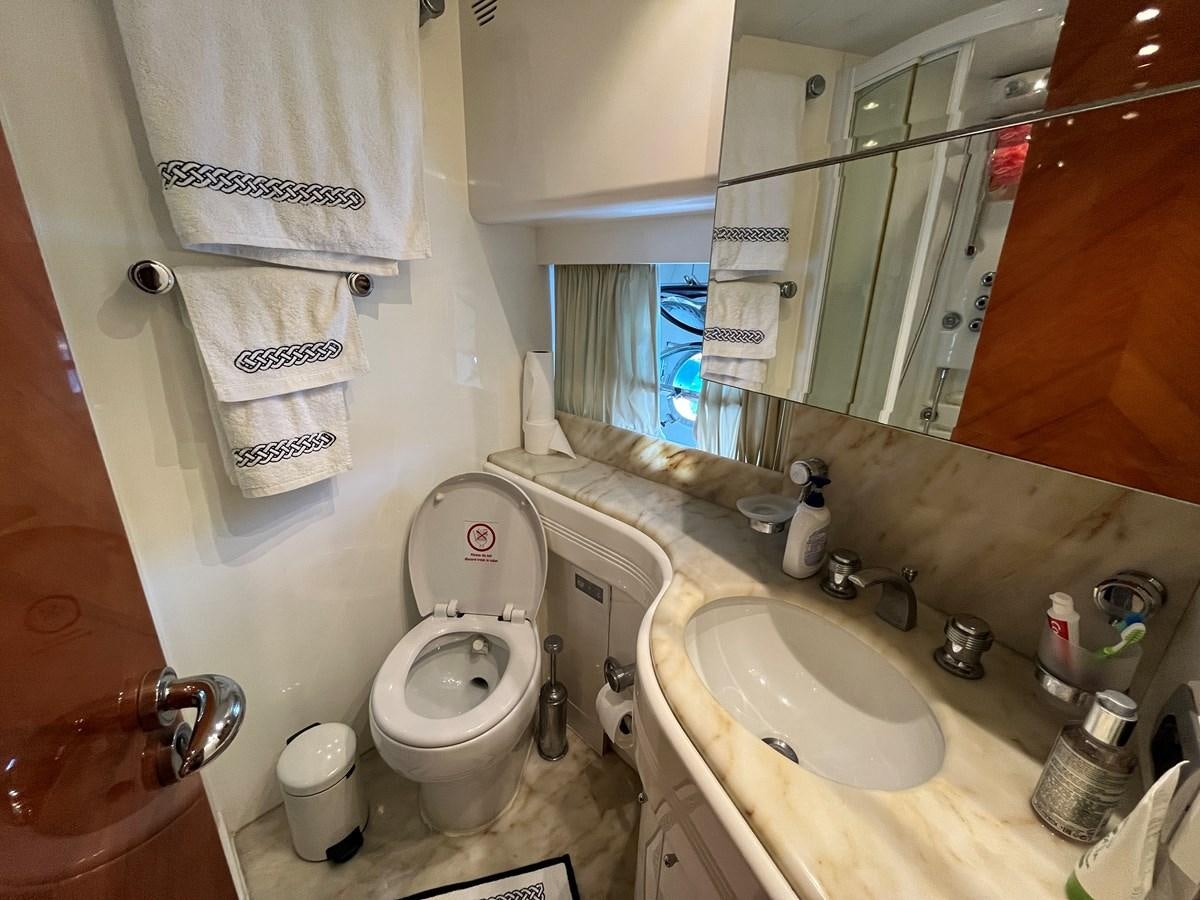 a bathroom with a toilet sink and mirror aboard AZIMUT 85 Yacht for Sale