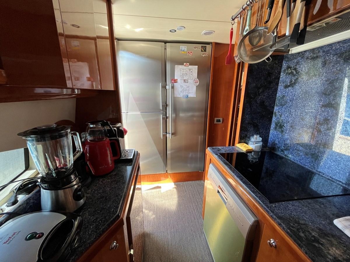 a kitchen with a stainless steel refrigerator aboard AZIMUT 85 Yacht for Sale