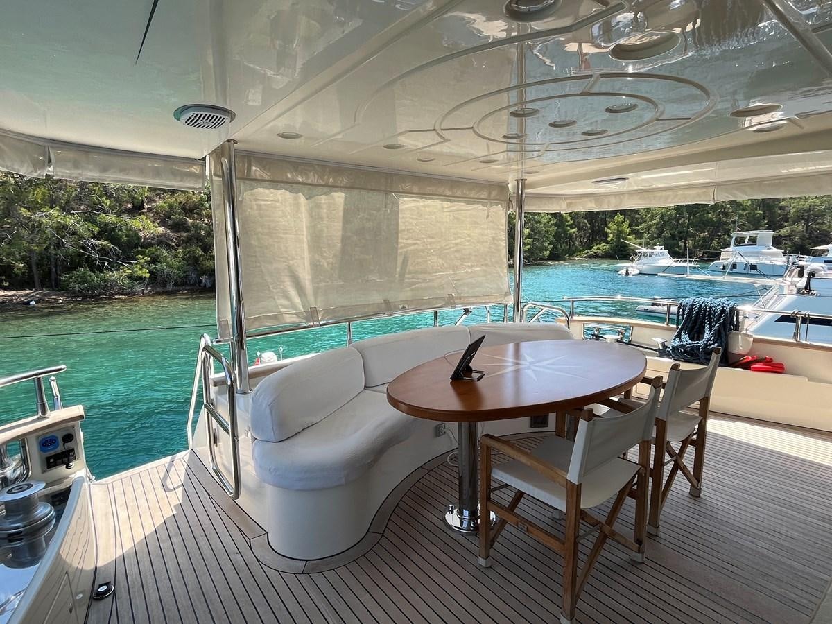 a table and chairs on a deck aboard AZIMUT 85 Yacht for Sale