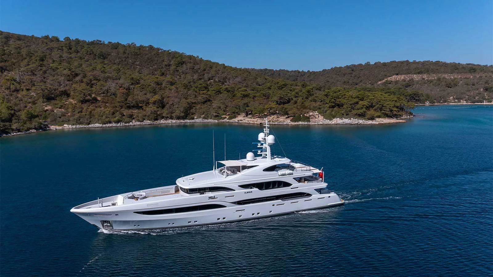 a white yacht in the water aboard ILERIA Yacht for Sale
