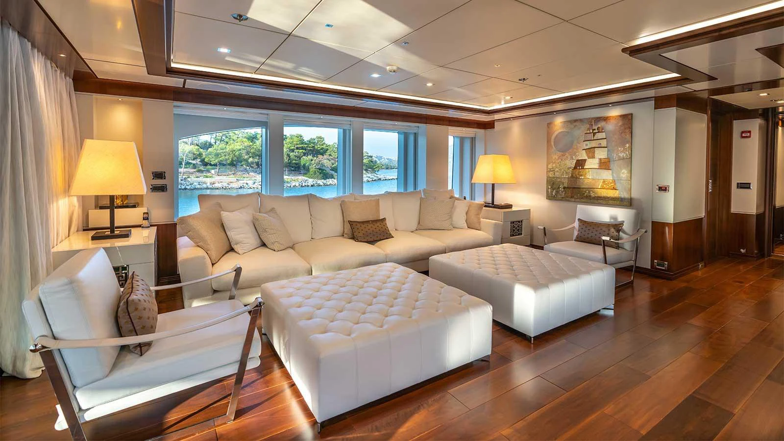 a large living room with a large window aboard ILERIA Yacht for Sale