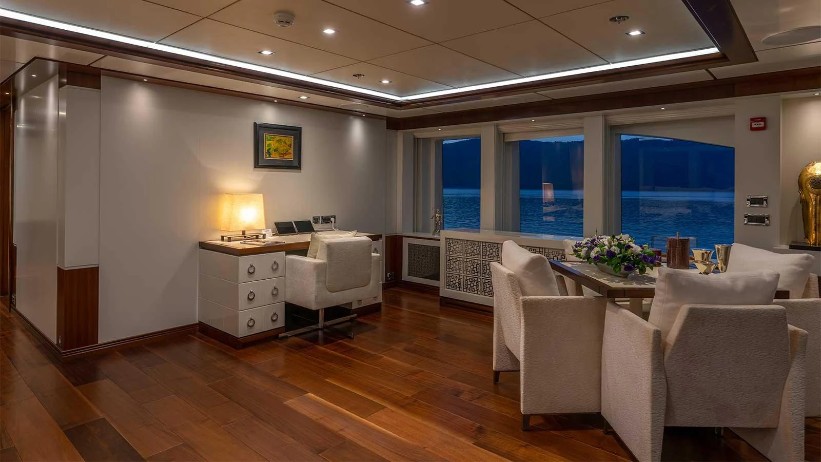 a room with a table chairs and a window aboard ILERIA Yacht for Sale