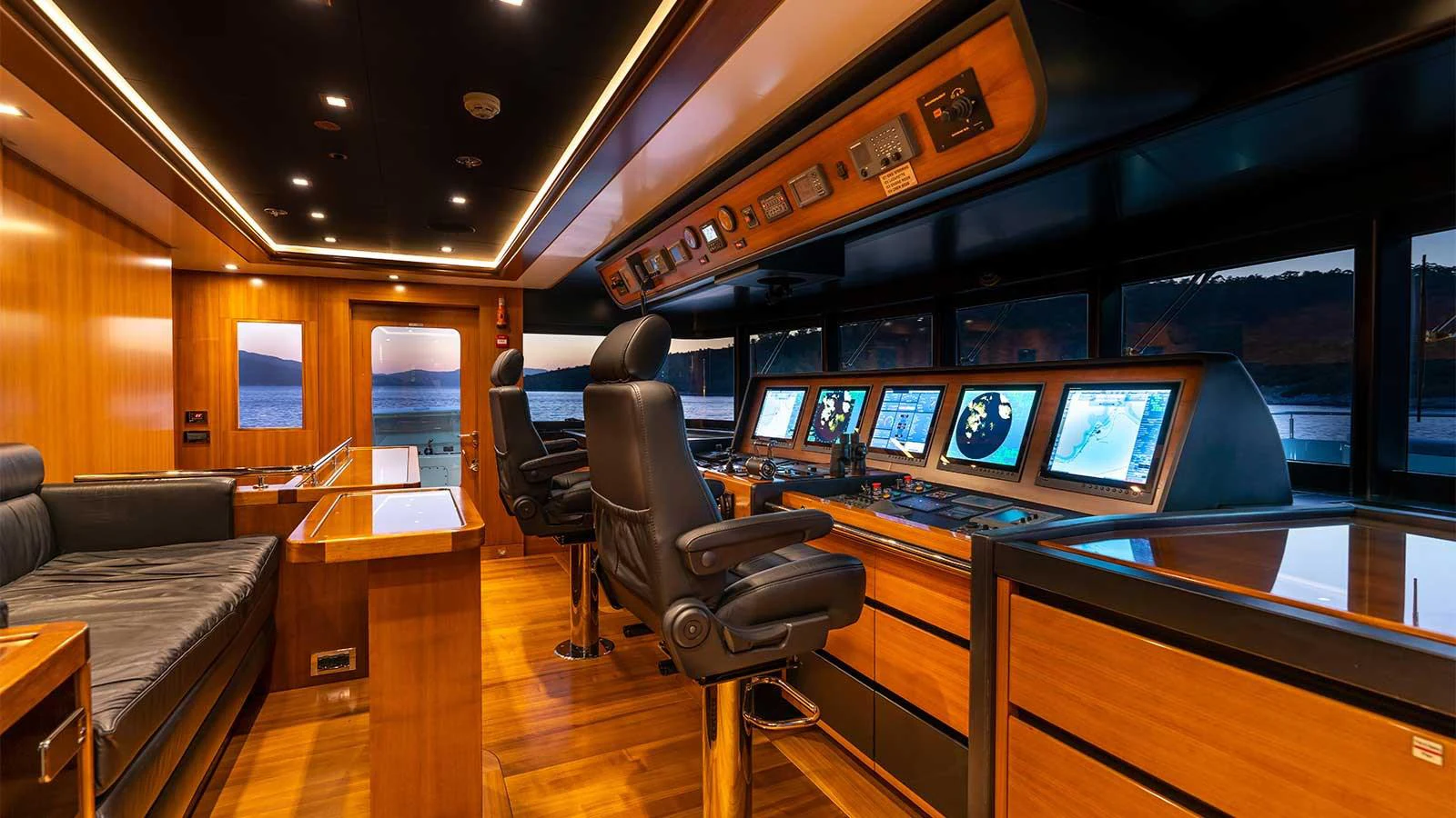 a room with a desk and chairs aboard ILERIA Yacht for Sale