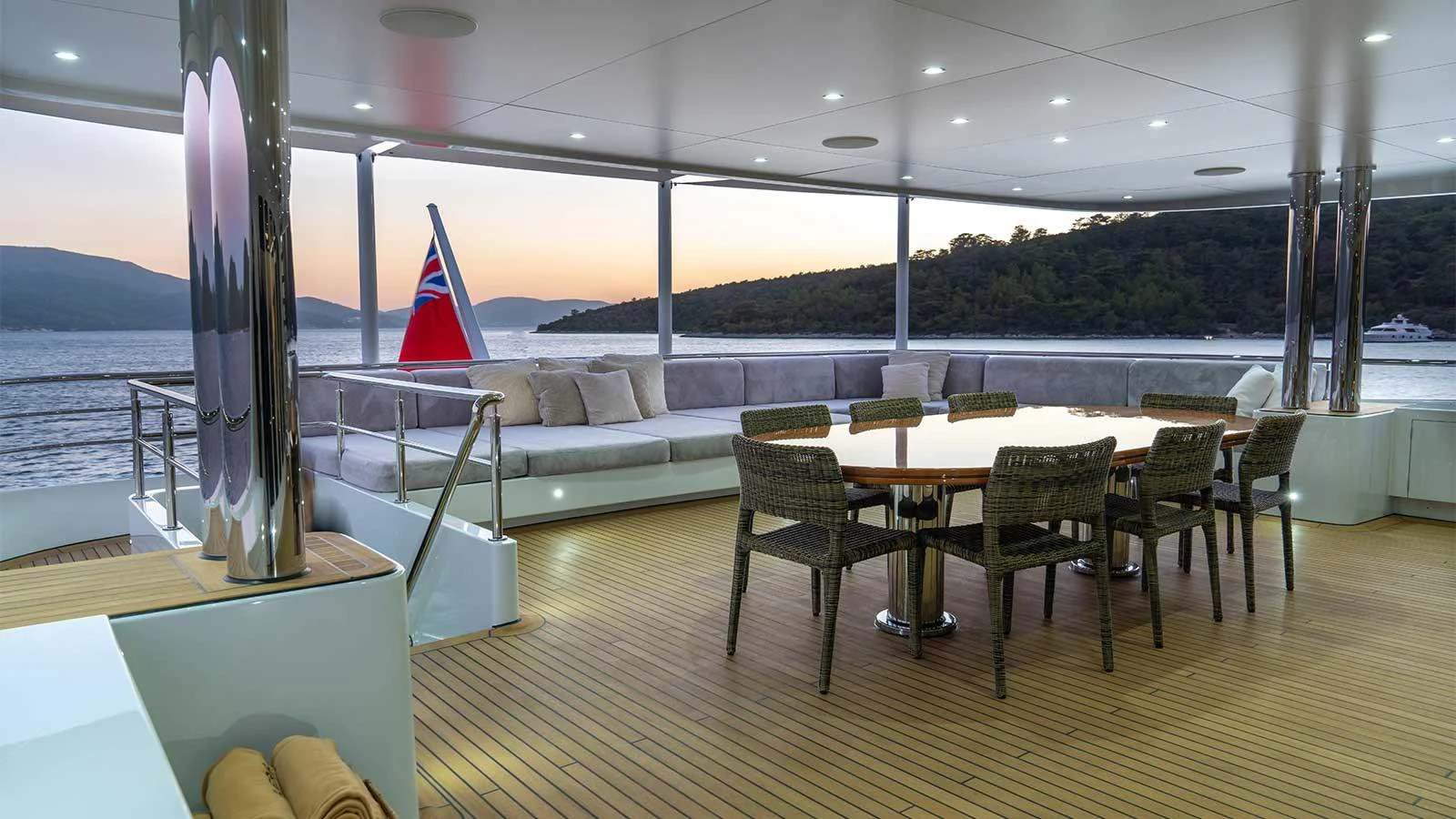 a room with a table and chairs aboard ILERIA Yacht for Sale