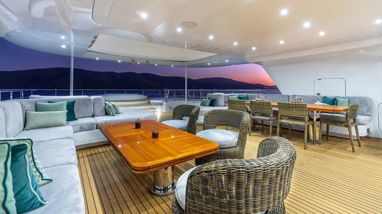 a large room with a table and chairs aboard ILERIA Yacht for Sale