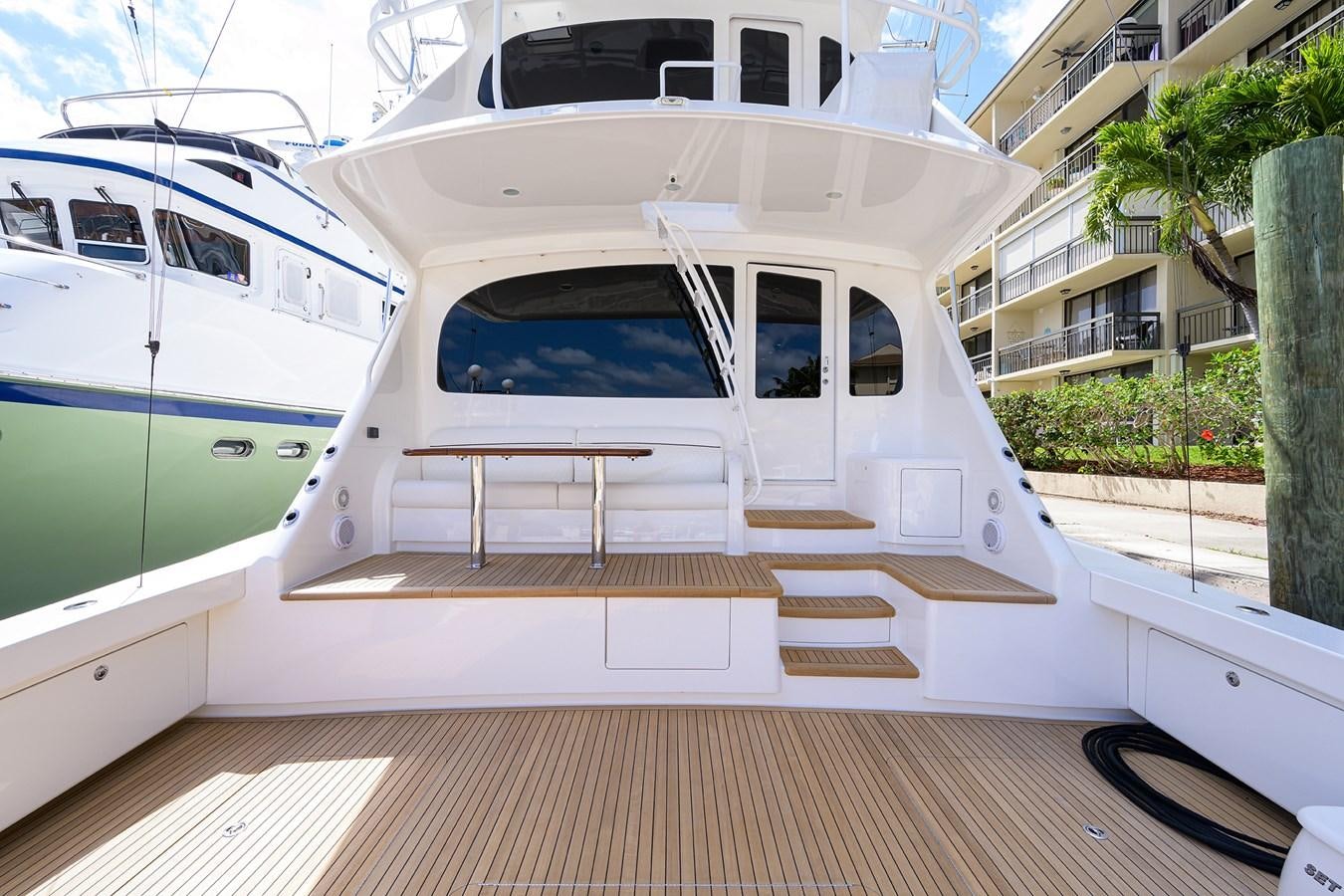 a white boat on a deck aboard ENCLOSED BRIDGE Yacht for Sale