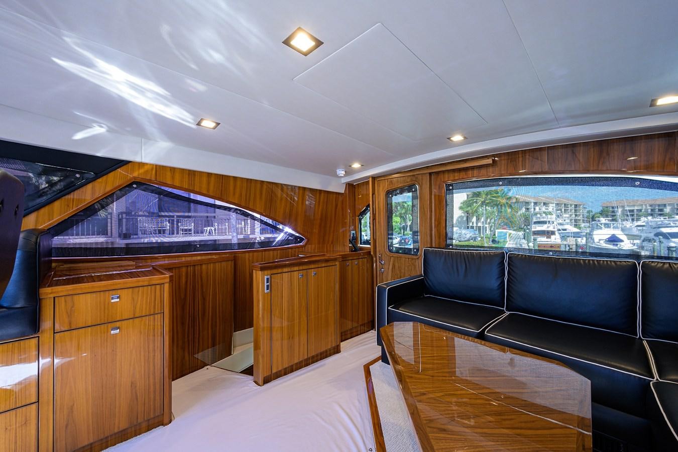 a room with a pool table and couches aboard ENCLOSED BRIDGE Yacht for Sale