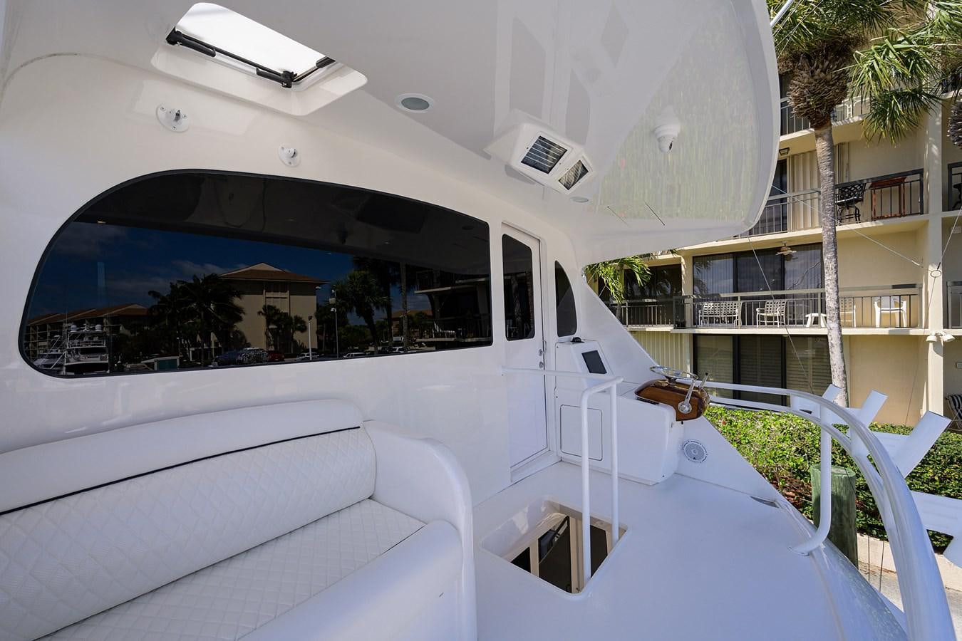 a white car with a window aboard ENCLOSED BRIDGE Yacht for Sale