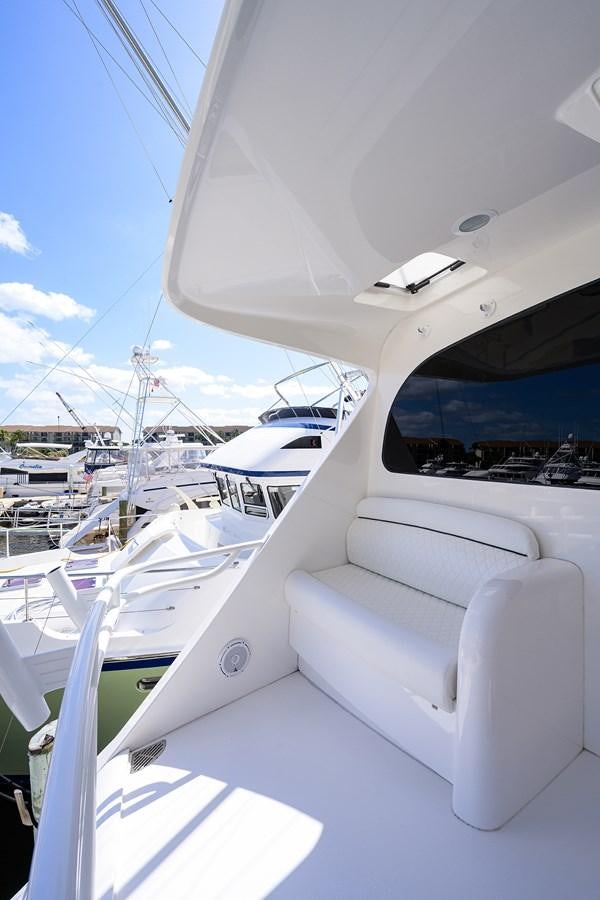 a white boat in a harbor aboard ENCLOSED BRIDGE Yacht for Sale