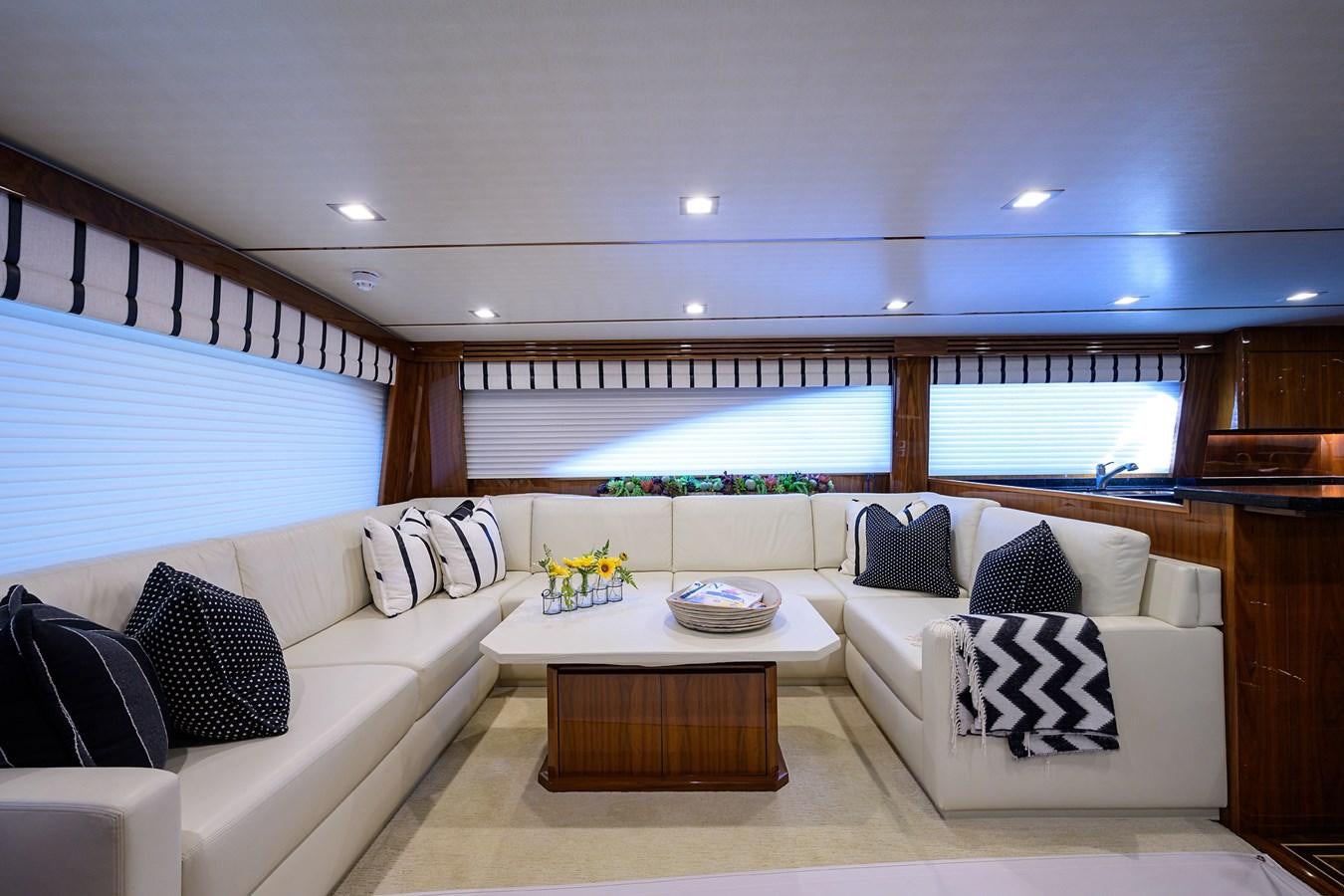 a living room with a large window aboard ENCLOSED BRIDGE Yacht for Sale