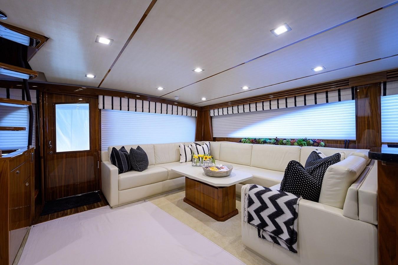 a living room with white furniture aboard ENCLOSED BRIDGE Yacht for Sale