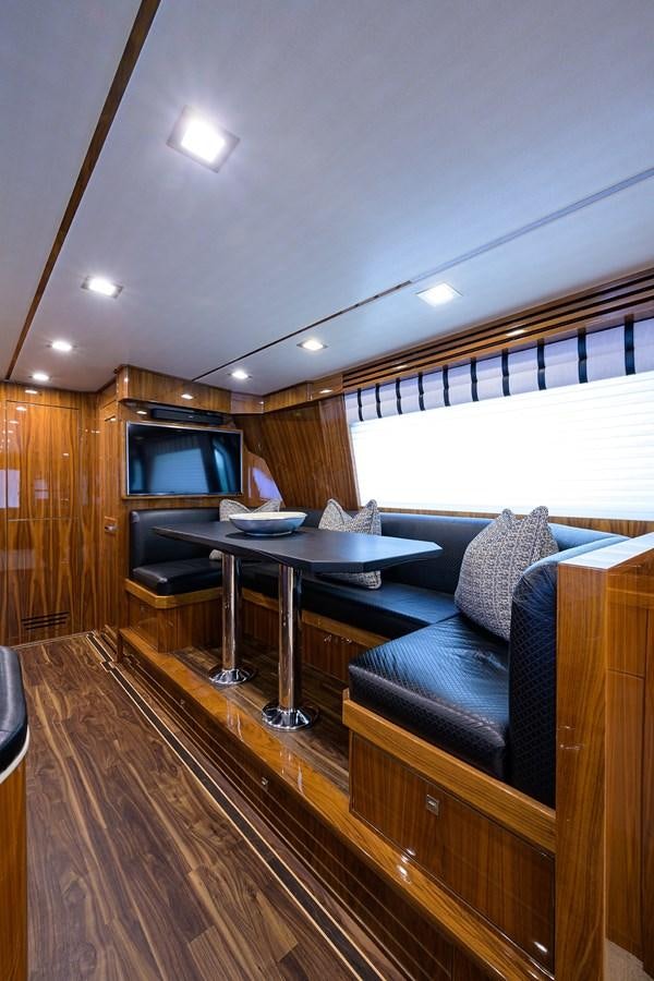 a living room with a couch and a table aboard ENCLOSED BRIDGE Yacht for Sale