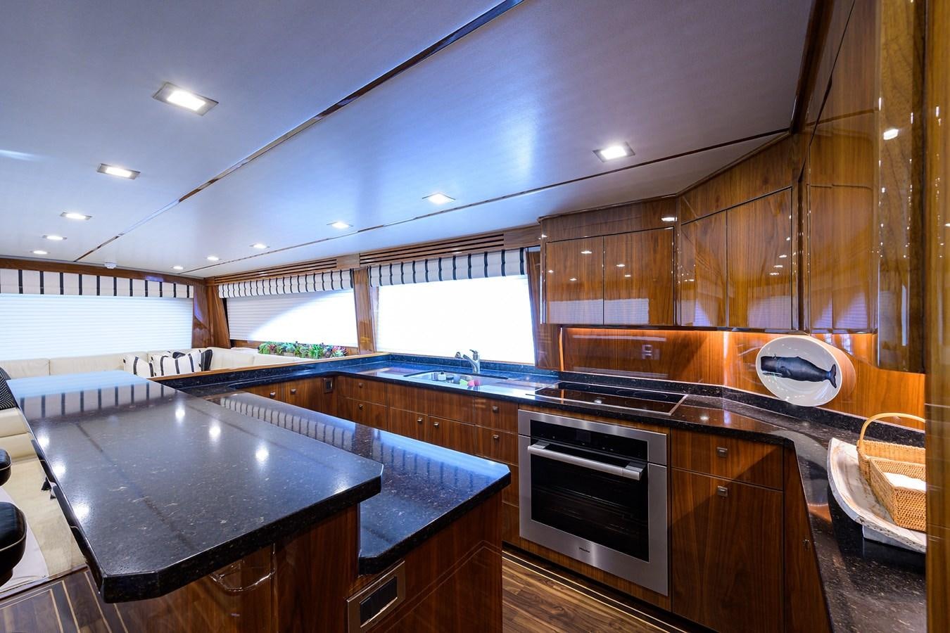 a kitchen with wooden cabinets aboard ENCLOSED BRIDGE Yacht for Sale