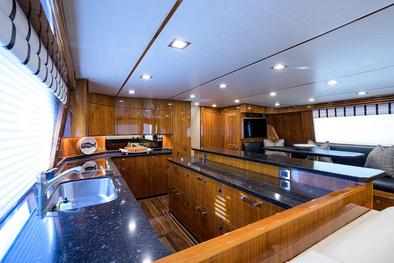 a kitchen with a large island aboard ENCLOSED BRIDGE Yacht for Sale
