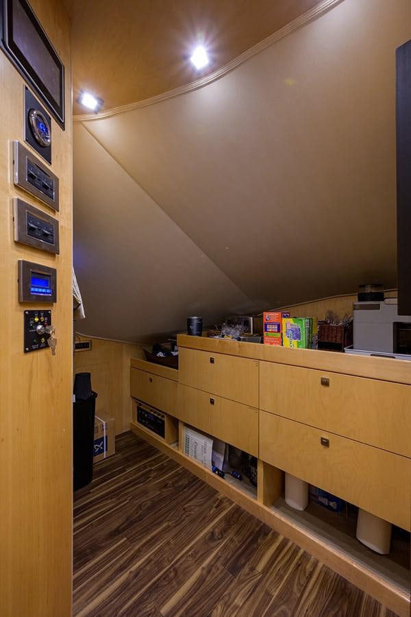 a room with a wood cabinet and shelves with objects on it aboard ENCLOSED BRIDGE Yacht for Sale