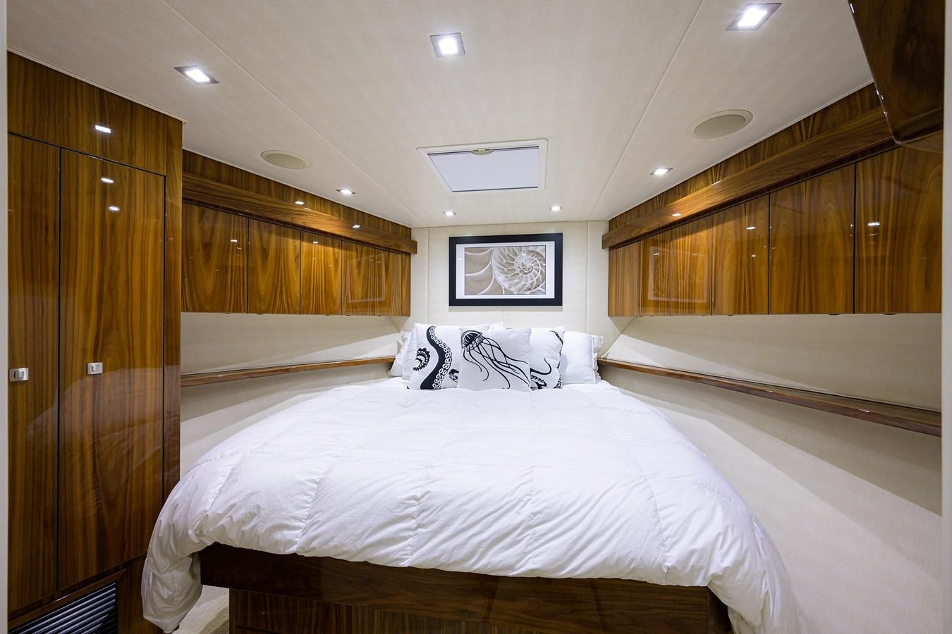 a room with a bed and a television aboard ENCLOSED BRIDGE Yacht for Sale
