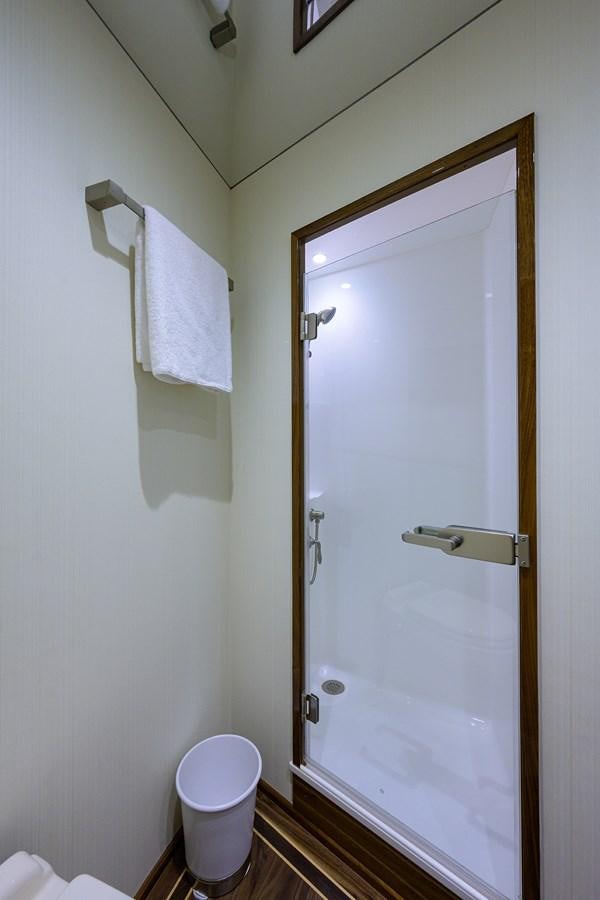 a bathroom with a shower and toilet aboard ENCLOSED BRIDGE Yacht for Sale