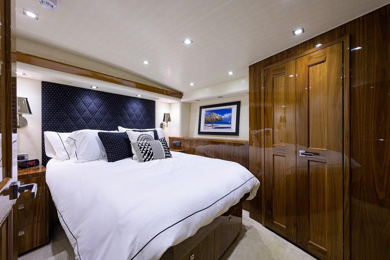 a bedroom with a bed and a closet aboard ENCLOSED BRIDGE Yacht for Sale