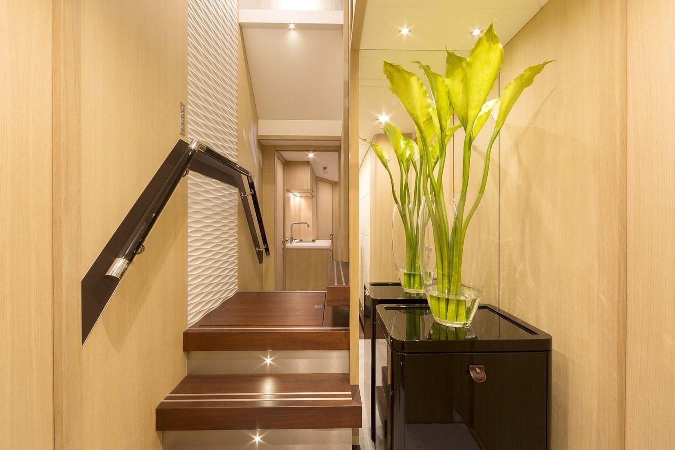 a vase with flowers on a table aboard O NOSO UNO Yacht for Sale