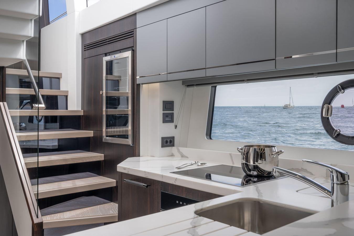a kitchen with a sink and a staircase aboard PREDATOR 74 XPS Yacht for Sale