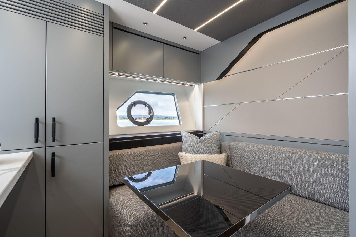 a room with a couch and a table aboard PREDATOR 74 XPS Yacht for Sale