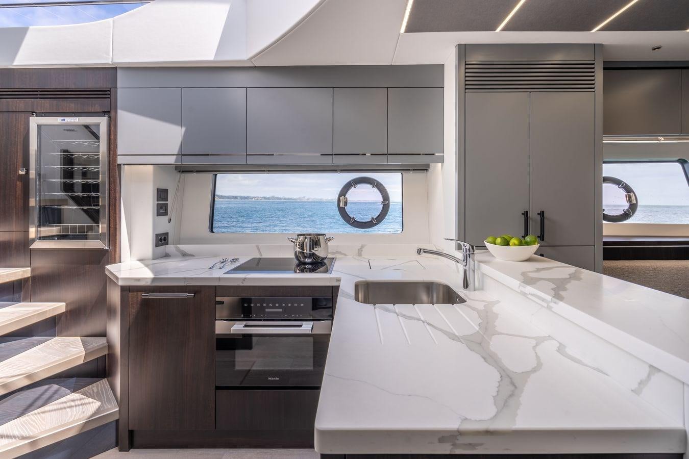 a kitchen with a sink and cabinets aboard PREDATOR 74 XPS Yacht for Sale