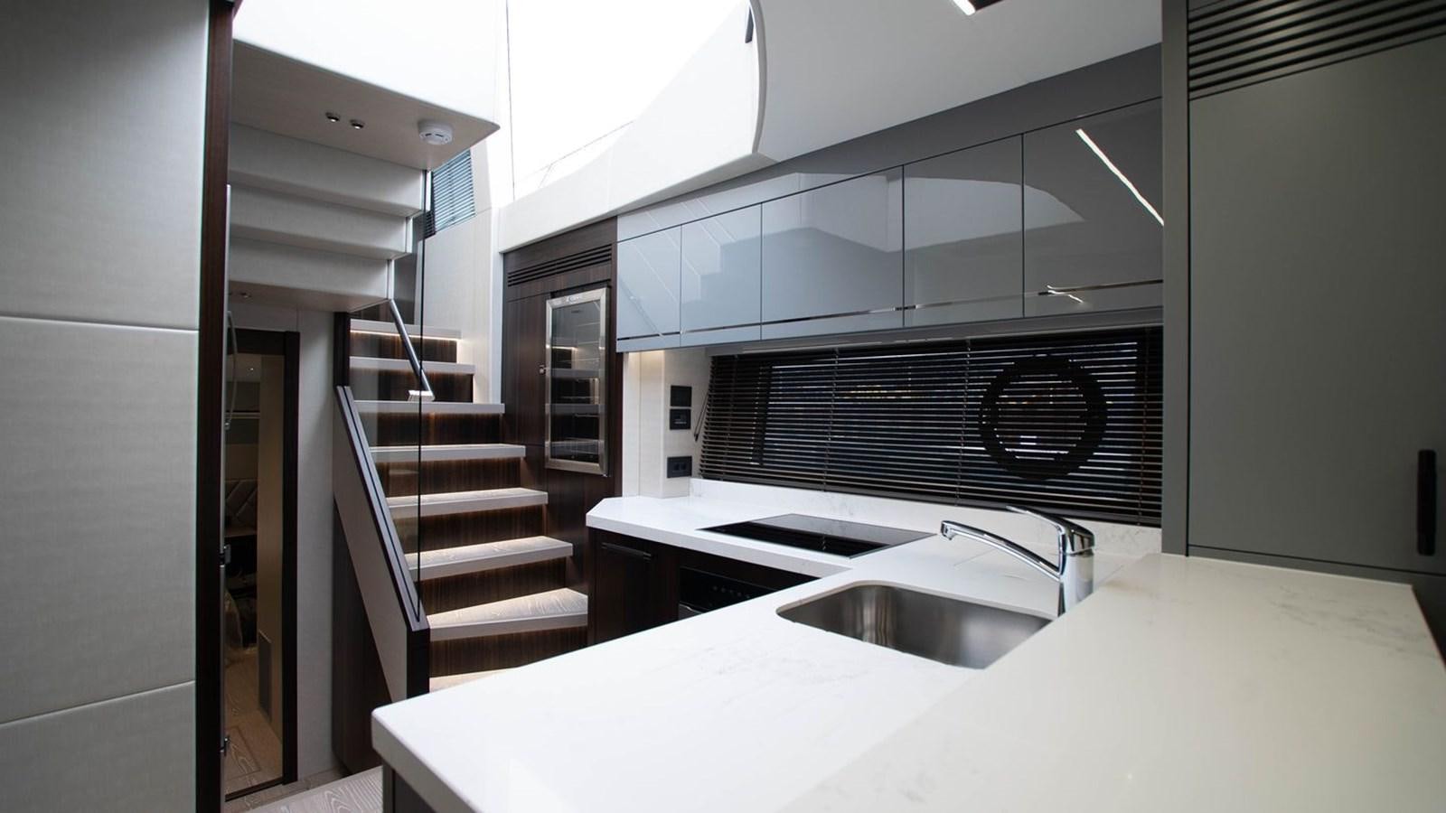 a kitchen with a sink and a stove aboard PREDATOR 74 XPS Yacht for Sale